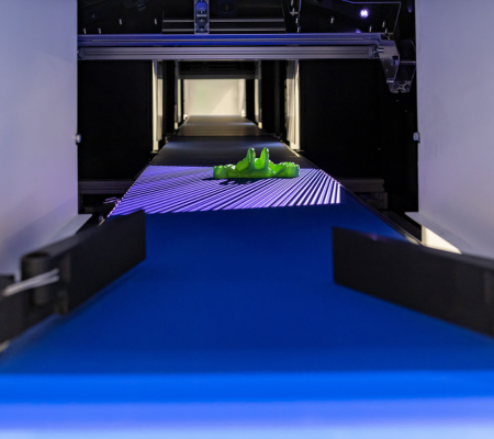 Part on conveyor belt being scanned for identification